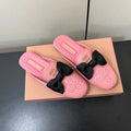 BOW MULES IN PINK SHEEPSKIN