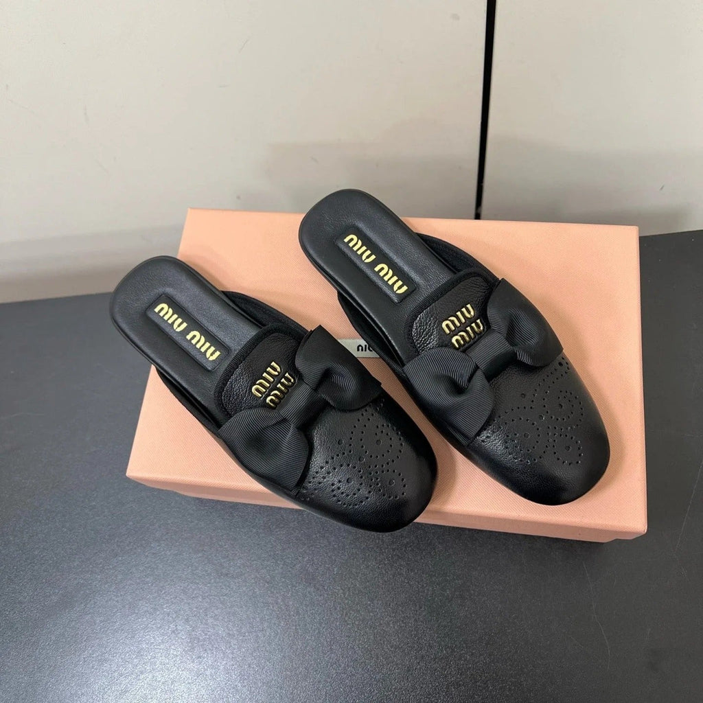 BOW MULES IN BLACK SHEEPSKIN