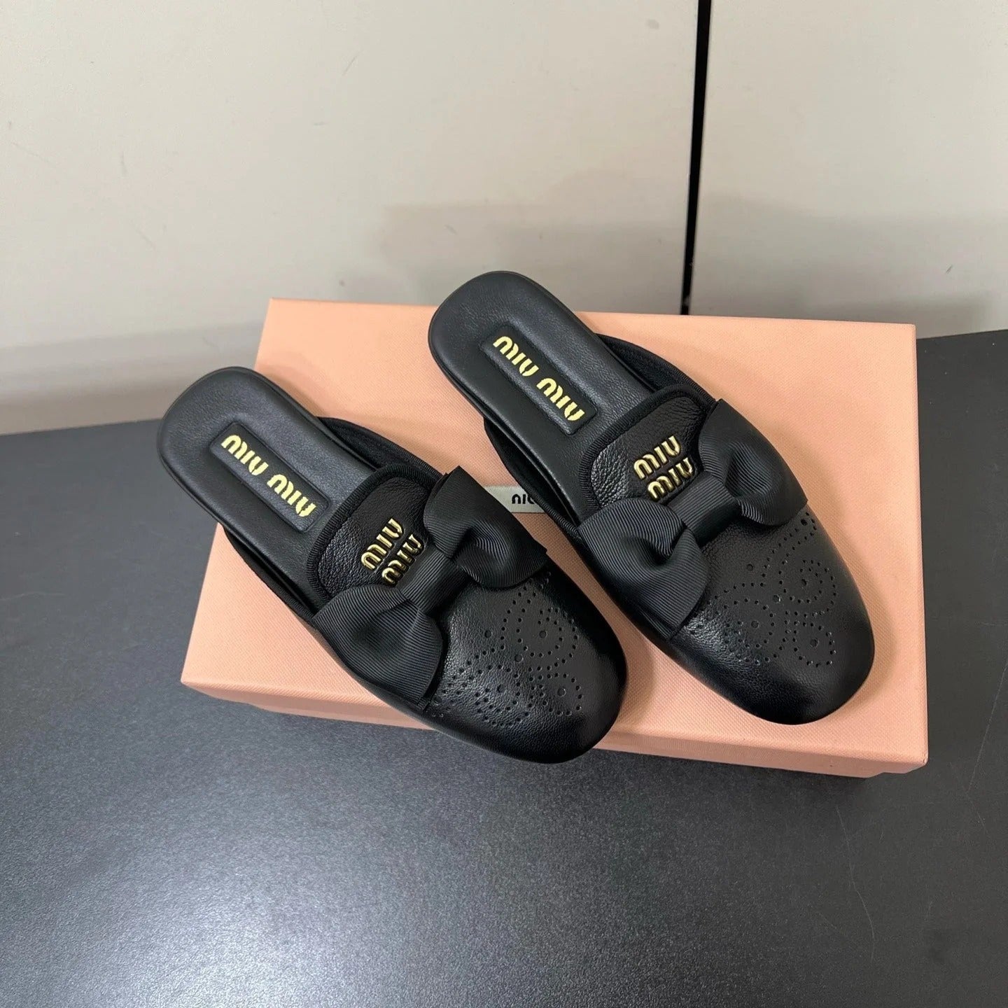 BOW MULES IN BLACK SHEEPSKIN